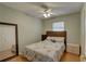 Tranquil bedroom features a bed with themed bedding, natural light, and a modern ceiling fan at 9240 53Rd N Way, Pinellas Park, FL 33782