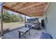 Cozy covered patio area with an outdoor kitchen, grill, and ample space for entertaining guests at 9240 53Rd N Way, Pinellas Park, FL 33782