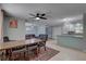 Open dining area with a rustic table and chairs flowing into a comfortable living space and kitchen at 9240 53Rd N Way, Pinellas Park, FL 33782