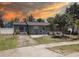 Charming single-story home featuring blue shutters, well-manicured landscaping, and a cozy front porch at 9240 53Rd N Way, Pinellas Park, FL 33782