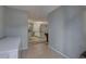 Hallway view into a renovated kitchen and open living space, with tile flooring and neutral paint at 9240 53Rd N Way, Pinellas Park, FL 33782