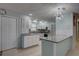 Bright kitchen with granite countertops, stainless steel appliances, and a stylish modern chandelier at 9240 53Rd N Way, Pinellas Park, FL 33782