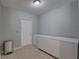 Bright laundry room with tiled floor, white door, and ample space for two freezers at 9240 53Rd N Way, Pinellas Park, FL 33782
