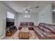 Comfortable living room features dual leather sofas, neutral walls, a TV, and a ceiling fan at 9240 53Rd N Way, Pinellas Park, FL 33782