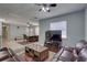Cozy living room with plush leather seating and a large window providing natural light and ceiling fan at 9240 53Rd N Way, Pinellas Park, FL 33782