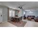 Open-concept living and dining area featuring tile flooring, fan, and a seamless transition to the living room at 9240 53Rd N Way, Pinellas Park, FL 33782