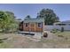 Backyard shed with a small front porch and green trim, providing extra storage space at 9240 53Rd N Way, Pinellas Park, FL 33782