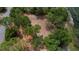 Aerial view of the lot surrounded by trees next to the neighborhood pond at 10040 Lake Dr, Weeki Wachee, FL 34613