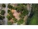 Aerial view of cleared land with tree coverage next to a street and pond at 10040 Lake Dr, Weeki Wachee, FL 34613