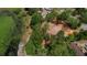 Aerial view of property bordered by pond, trees and existing neighborhood houses at 10040 Lake Dr, Weeki Wachee, FL 34613