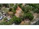 Aerial view of neighborhood lot next to lake, surrounded by trees and houses at 10040 Lake Dr, Weeki Wachee, FL 34613