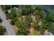 Aerial view of lot next to the road, surrounded by trees and a pond at 10040 Lake Dr, Weeki Wachee, FL 34613