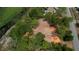 Aerial view of property near pond, surrounded by trees and houses at 10040 Lake Dr, Weeki Wachee, FL 34613