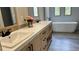 Bright bathroom featuring a double sink vanity with marble countertops and wood cabinets at 10040 Lake Dr, Weeki Wachee, FL 34613