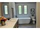 A modern bathroom featuring a large soaking tub and double sinks at 10040 Lake Dr, Weeki Wachee, FL 34613