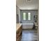 A modern bathroom featuring a large soaking tub and double sinks at 10040 Lake Dr, Weeki Wachee, FL 34613