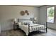 Bedroom features a sleek black metal bed frame, complementing light wood-look flooring at 10040 Lake Dr, Weeki Wachee, FL 34613