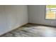 Bedroom features sleek, modern flooring, light-colored walls, and a bright window at 10040 Lake Dr, Weeki Wachee, FL 34613