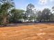 Cleared lot ready for construction with equipment visible and water views in the distance at 10040 Lake Dr, Weeki Wachee, FL 34613
