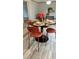 Dining room featuring a round table set for four, modern chairs, and stylish decor at 10040 Lake Dr, Weeki Wachee, FL 34613