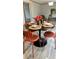 Dining room featuring a round table set for four, modern chairs, and stylish decor at 10040 Lake Dr, Weeki Wachee, FL 34613