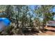 Wooded lot with a view of a home in the distance at 10040 Lake Dr, Weeki Wachee, FL 34613