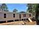 Exterior view of the light colored home with dark trim, dark door, and ample windows at 10040 Lake Dr, Weeki Wachee, FL 34613