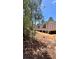 Exterior of a light colored modern house with multiple windows and dark trim, nestled in a wooded area at 10040 Lake Dr, Weeki Wachee, FL 34613