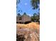 Exterior of home construction, with a light-colored house, dark trim and spacious lot with surrounding trees at 10040 Lake Dr, Weeki Wachee, FL 34613