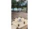 Picturesque backyard displaying a gravel fire pit area surrounded by stump seating for outdoor enjoyment and relaxation at 10040 Lake Dr, Weeki Wachee, FL 34613