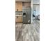 Kitchen featuring stainless refrigerator, light wood cabinets, and light countertops at 10040 Lake Dr, Weeki Wachee, FL 34613