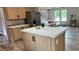 Kitchen island featuring marble countertops and a stainless-steel refrigerator at 10040 Lake Dr, Weeki Wachee, FL 34613
