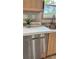 Close-up on stainless steel dishwasher and bright countertop, complemented by natural wood cabinets at 10040 Lake Dr, Weeki Wachee, FL 34613