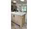 Kitchen island featuring marble countertops and a stainless-steel refrigerator at 10040 Lake Dr, Weeki Wachee, FL 34613