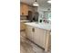 Kitchen island featuring marble countertops and a stainless-steel refrigerator at 10040 Lake Dr, Weeki Wachee, FL 34613