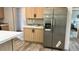 Kitchen featuring stainless refrigerator, light wood cabinets, and light countertops at 10040 Lake Dr, Weeki Wachee, FL 34613