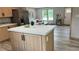 Kitchen island featuring marble countertops and a stainless-steel refrigerator at 10040 Lake Dr, Weeki Wachee, FL 34613