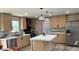 Modern kitchen boasts stainless steel appliances, a central island and stylish pendant lighting at 10040 Lake Dr, Weeki Wachee, FL 34613