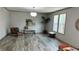 Bright living room features hardwood flooring and two windows at 10040 Lake Dr, Weeki Wachee, FL 34613
