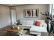 Stylish living room with a white sectional, modern art, and ample natural light at 10040 Lake Dr, Weeki Wachee, FL 34613