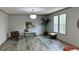 Bright living room features hardwood flooring and two windows at 10040 Lake Dr, Weeki Wachee, FL 34613