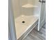 An accessible tiled shower with a corner seat at 10040 Lake Dr, Weeki Wachee, FL 34613