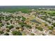 Overhead shot featuring the neighborhood with mature trees, community pond, and beautiful homes near local amenities at 10310 Salisbury St, Riverview, FL 33569