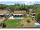 Aerial view of fenced backyard featuring pool, mature landscaping, and patio at 10310 Salisbury St, Riverview, FL 33569