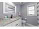Updated bathroom features granite countertops, a stylish mirror, and modern fixtures for a fresh appeal at 10310 Salisbury St, Riverview, FL 33569