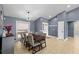 Bright dining room with a modern light fixture, seating for six, and a view of the outdoors at 10310 Salisbury St, Riverview, FL 33569