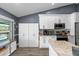 Charming kitchen featuring stainless steel appliances, granite counters, and custom white cabinetry at 10310 Salisbury St, Riverview, FL 33569