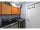 Functional laundry room equipped with modern washer and dryer units and ample storage space at 10310 Salisbury St, Riverview, FL 33569