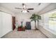 Cozy bedroom with carpet, neutral walls, ceiling fan and bright window at 105 N Comet Ave, Clearwater, FL 33765