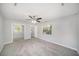 Large bedroom featuring neutral walls, plush carpet, a ceiling fan, and a mirrored closet at 105 N Comet Ave, Clearwater, FL 33765